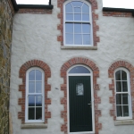 Loughbrickland Rd Banbridge Composite green T&G door with TG45 glass on cream frame and arch sliding sash windows.